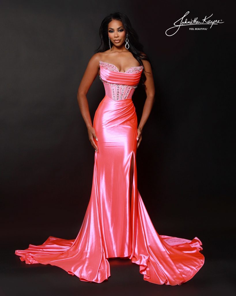 Johnathan Kayne Style 3203 in Hot Coral — a strapless satin gown with a jeweled corset bodice, draped neckline, thigh-high slit, and luxurious mermaid train; ideal for pageants, prom, and formal events.